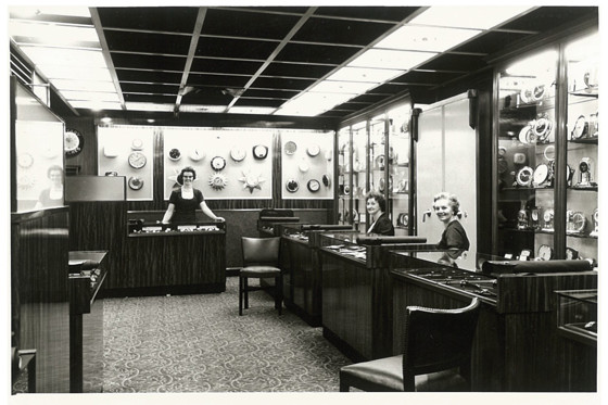 Historic black and white image of three women working in James Porter & Son